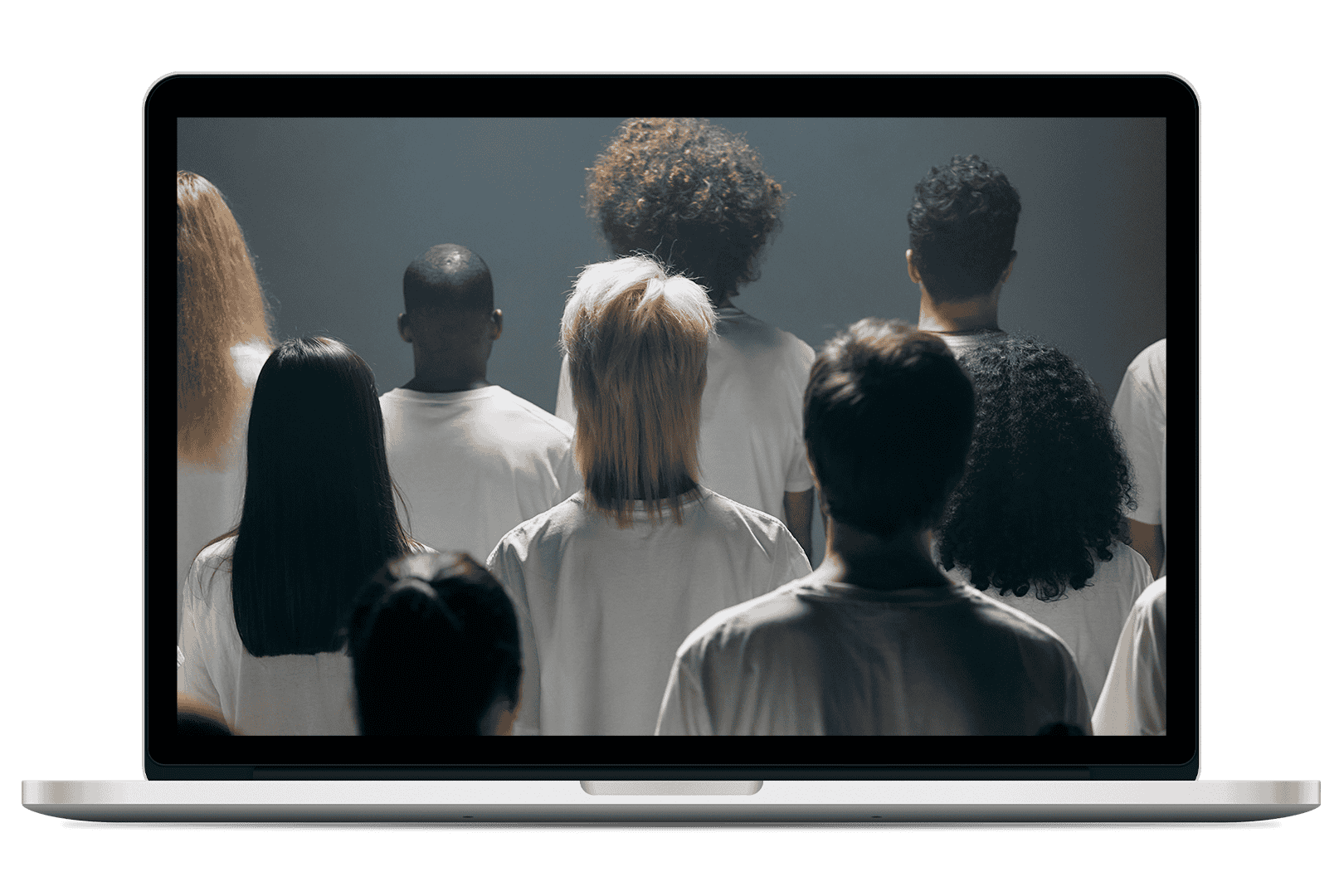 Image of laptop computer with a group of people standing together in matching shirts, viewed from behind in a studio setting.